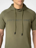 A man wearing an olive green short-sleeve hoodie with 'DISTINCT ONE' printed in gray across the chest, shown from the neck down against a light gray background.
